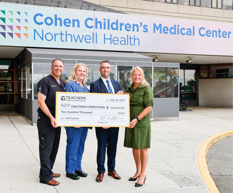 Image of hospital staff receiving donation from TFCU